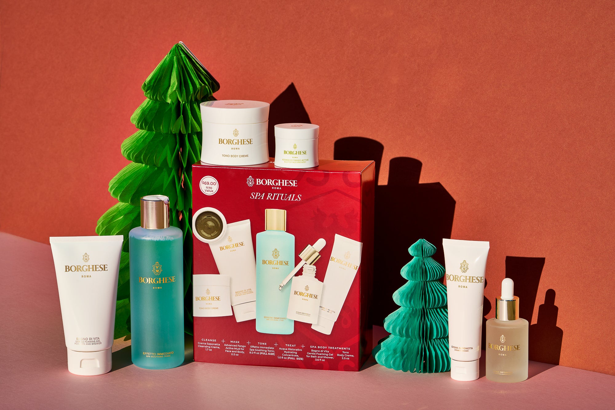 Borghese Spa Rituals Gift Set and contents in front of Christmas trees