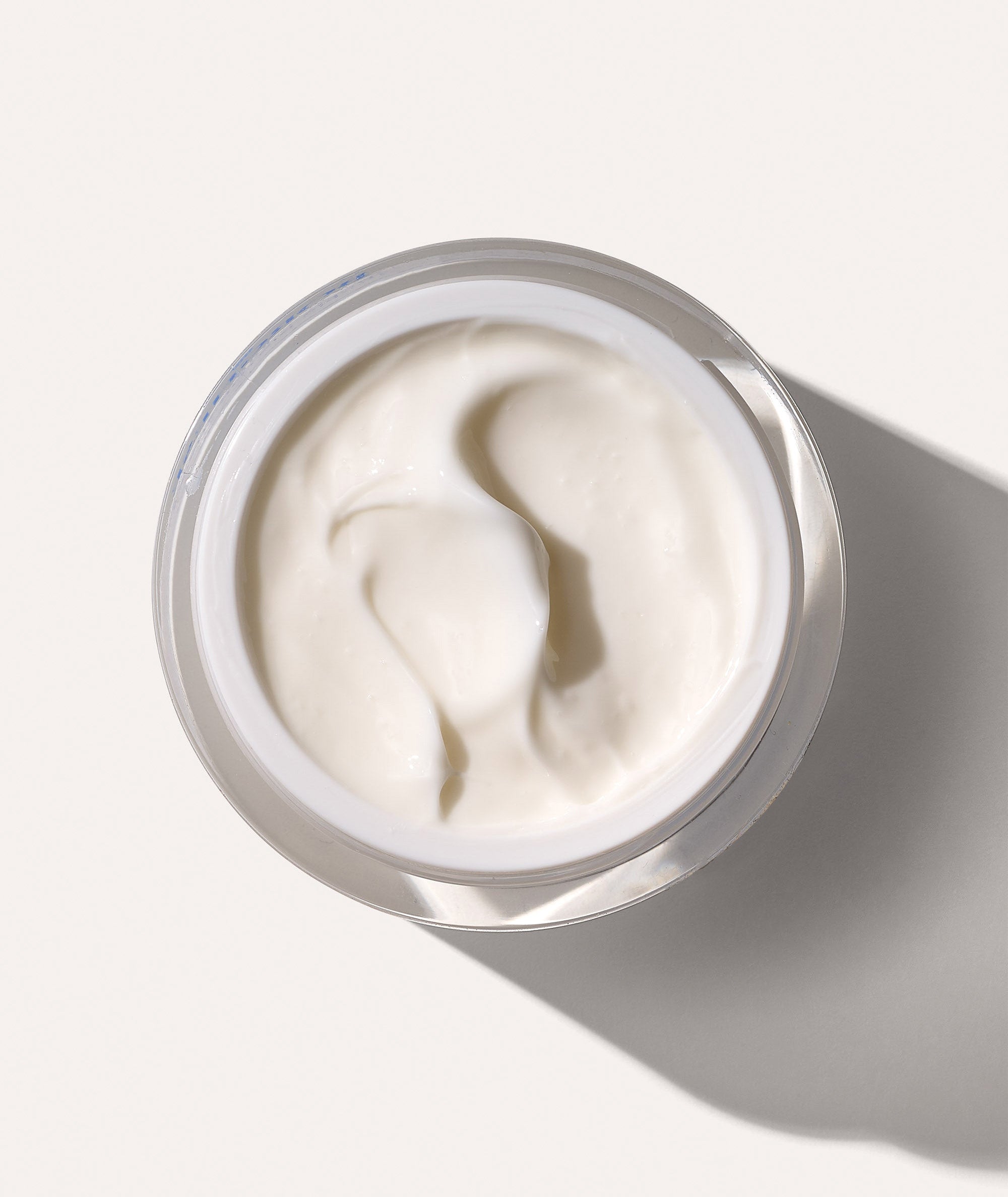 Aerial view of open jar showing the thick texture of our Crema Ristorativo-24 Moisturizer