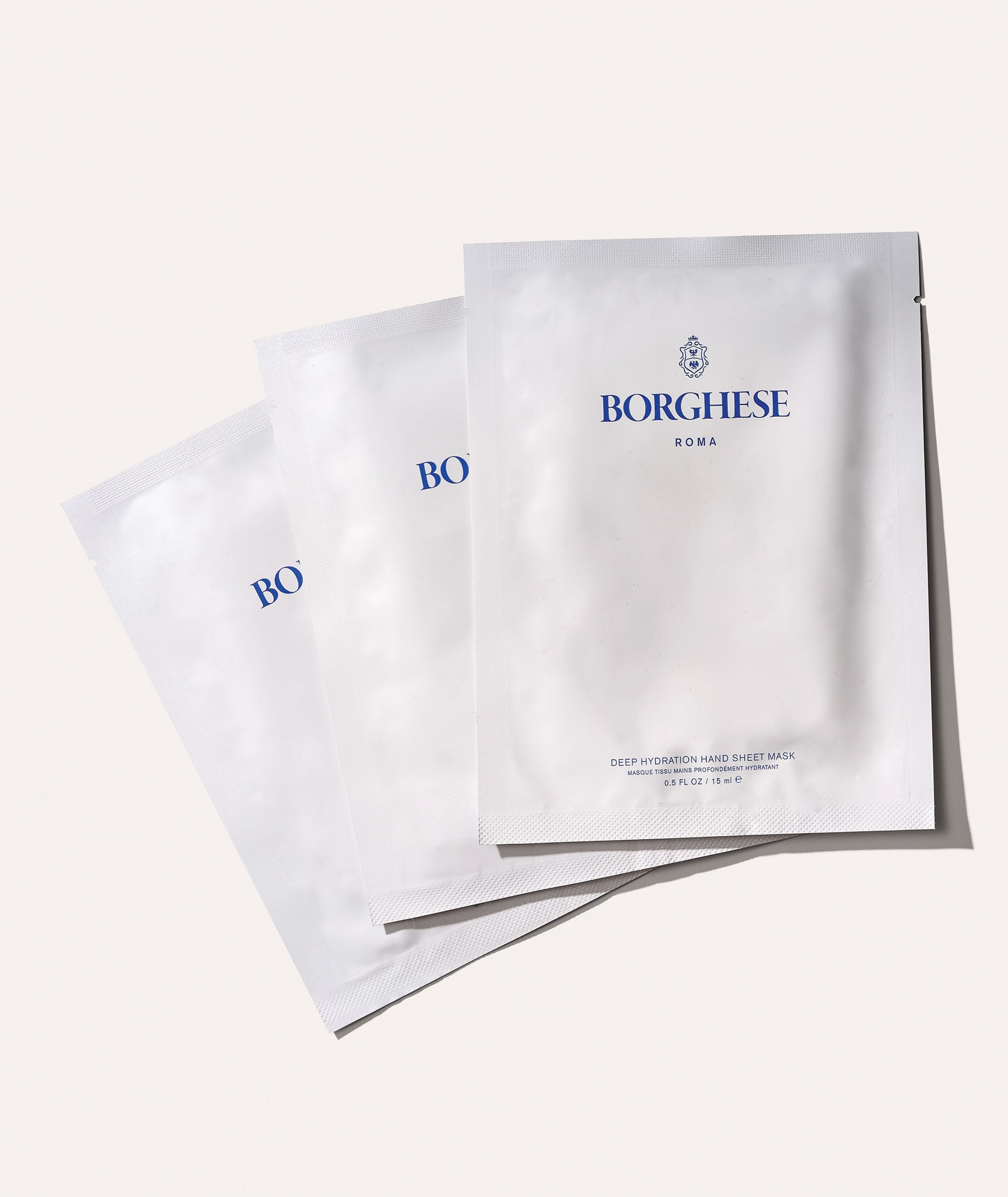 Flat of 3 pairs of our hand sheet masks in outer packaging showing they are individually packaged