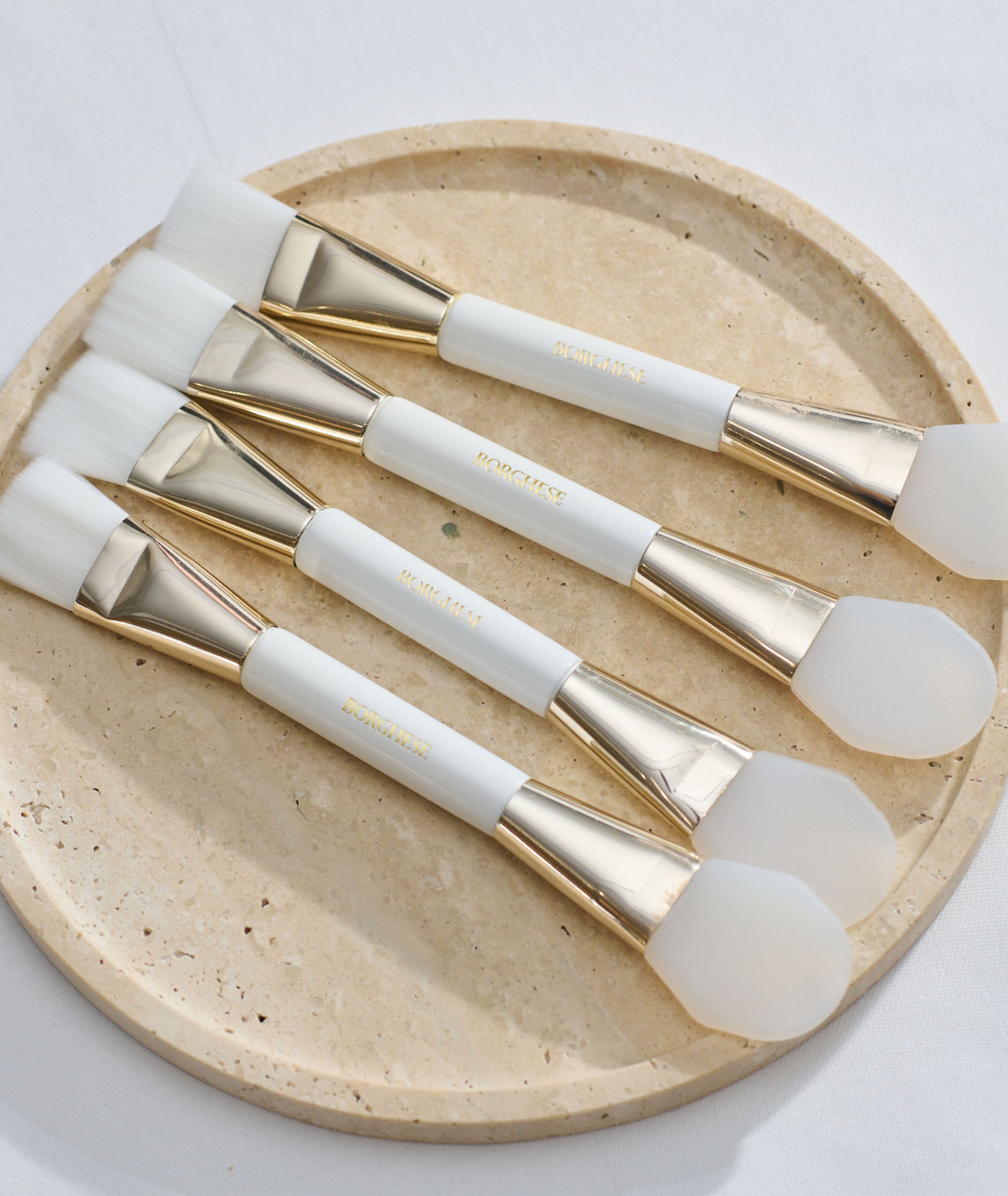 Grouped flat lay of multiple Deluxe Mask Applicators together on a tray