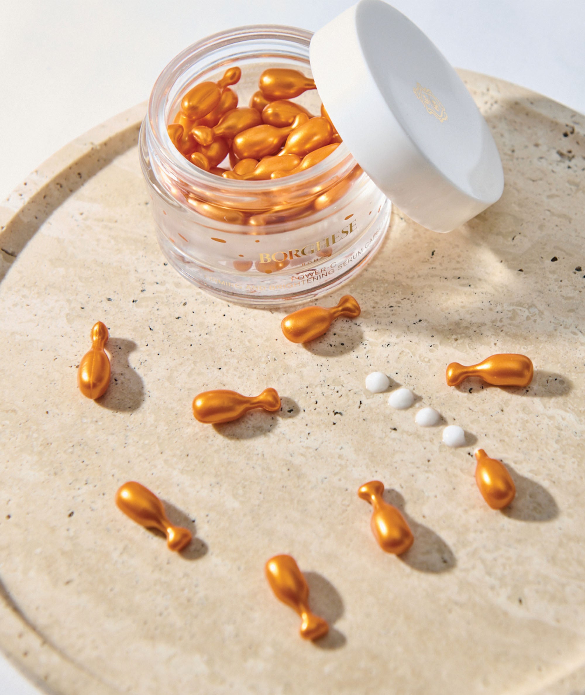 Open Jar of Power-C Firming & Brightening Serum Capsules showing an aerial view of capsules