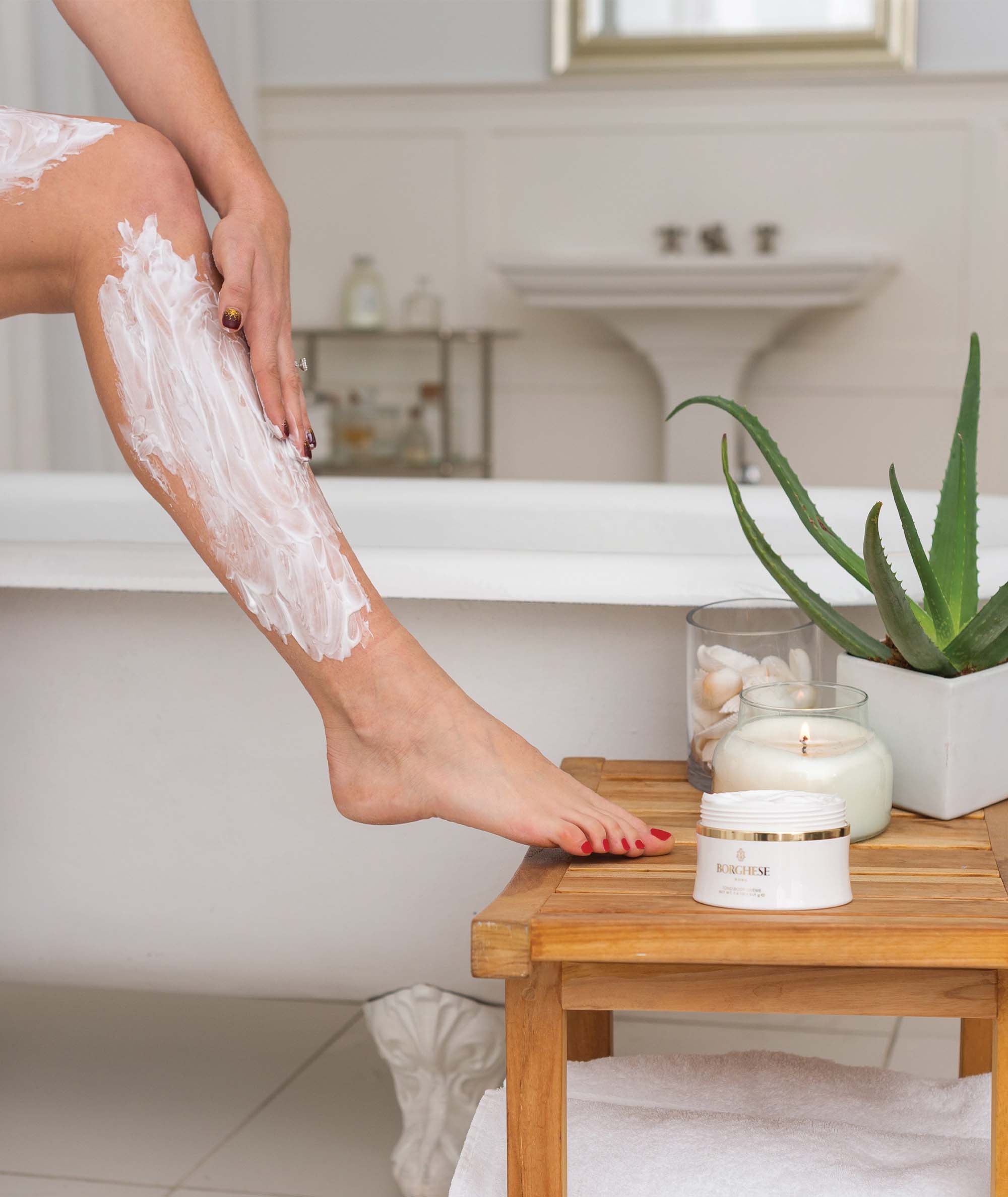 Model using the Tono Body Creme as a part of an at home spa routine in bathroom